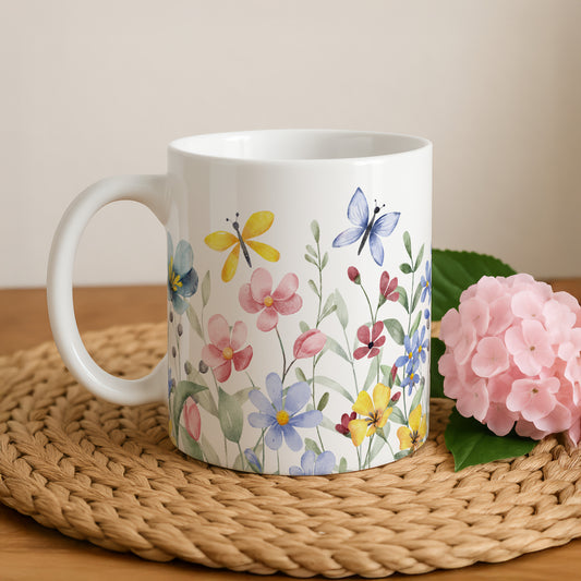 Ceramic cup with colorful wildflowers and butterflies, perfect for nature lovers.
